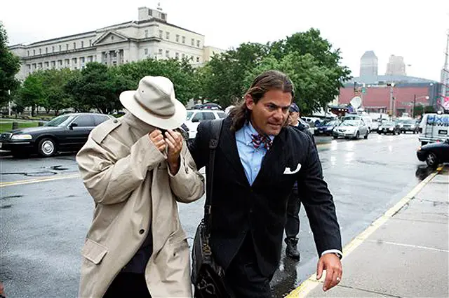 NJ Assemblyman Daniel Van Pelt tries to hide his face as his attorney escorts him to the courthouse